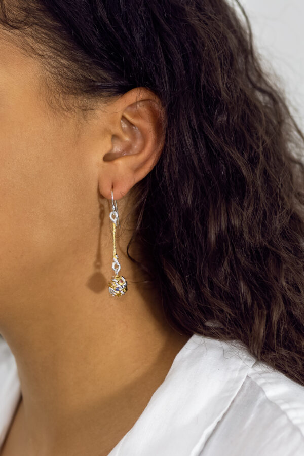 micro globo earrings being worn